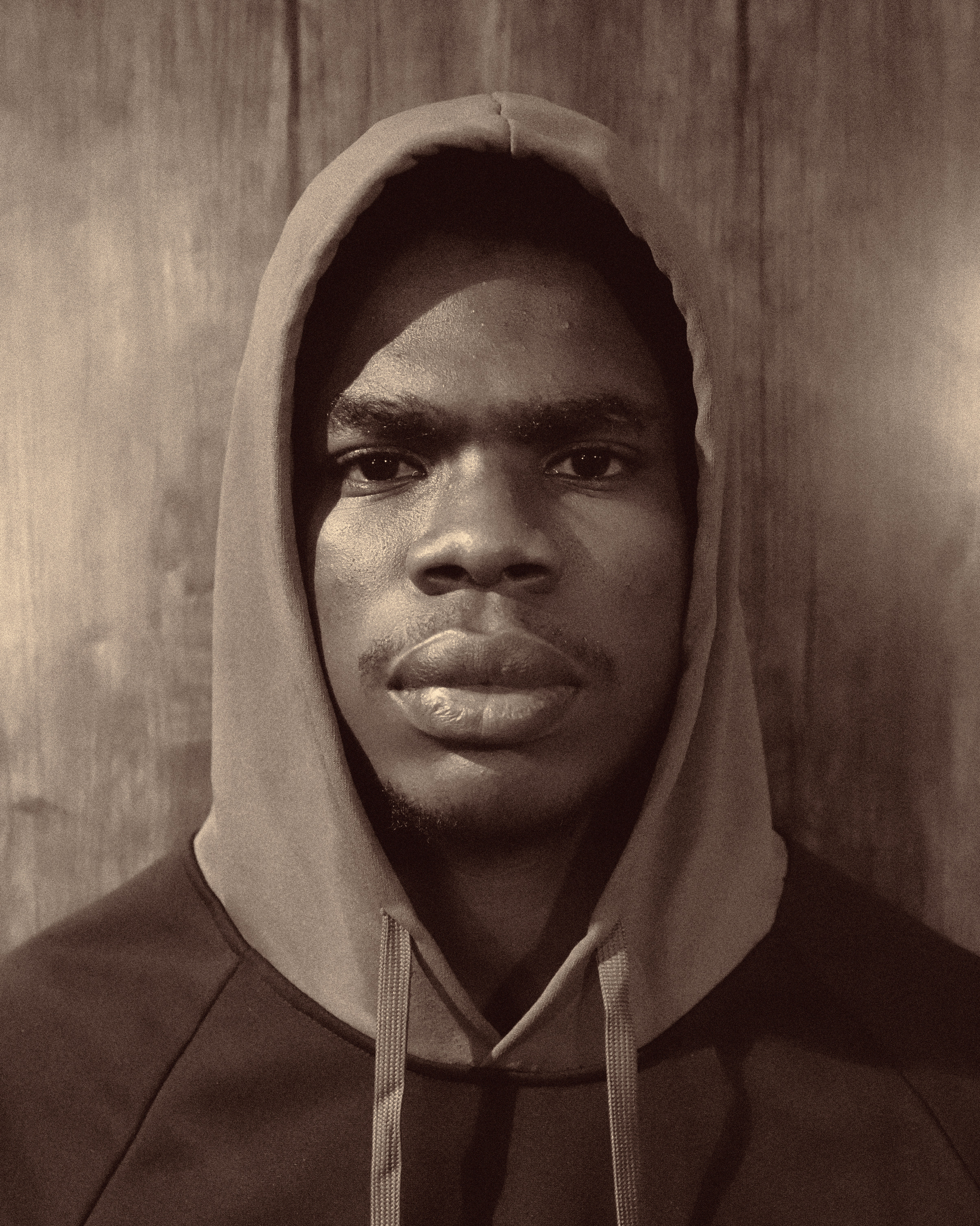 PaidLife – hooded portrait, warm tone